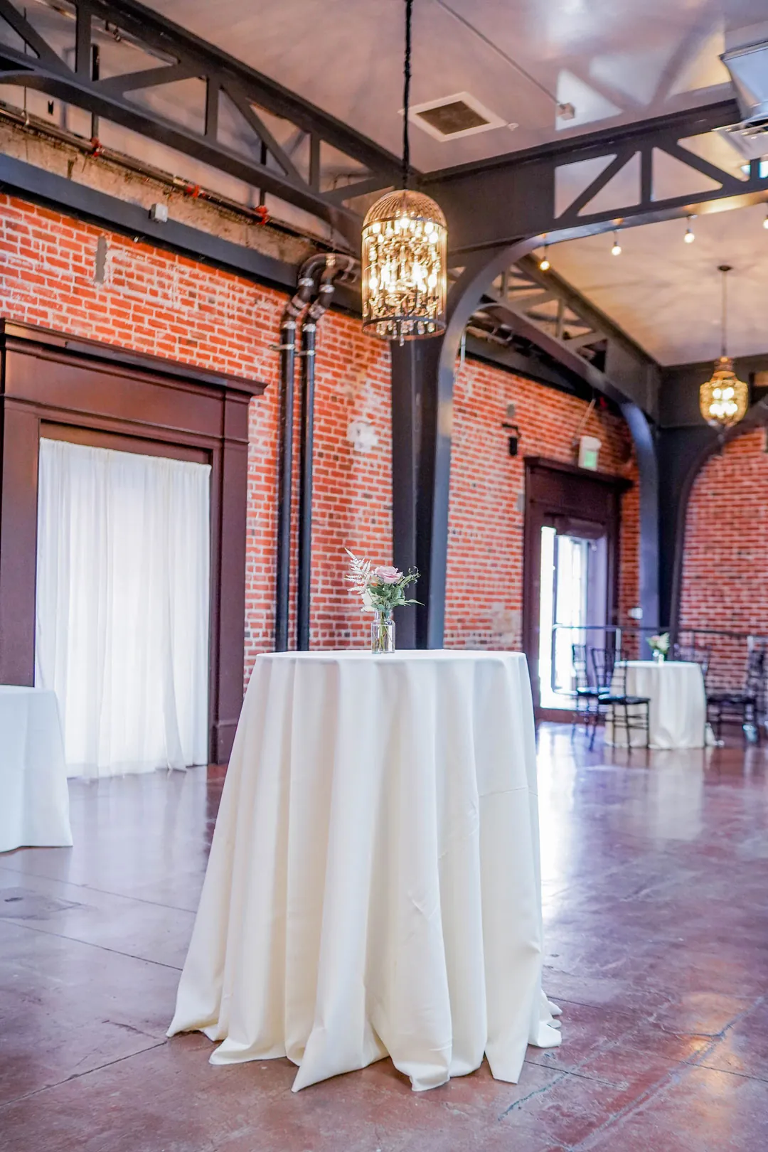 Tall cocktail table beneath a hanging lantern