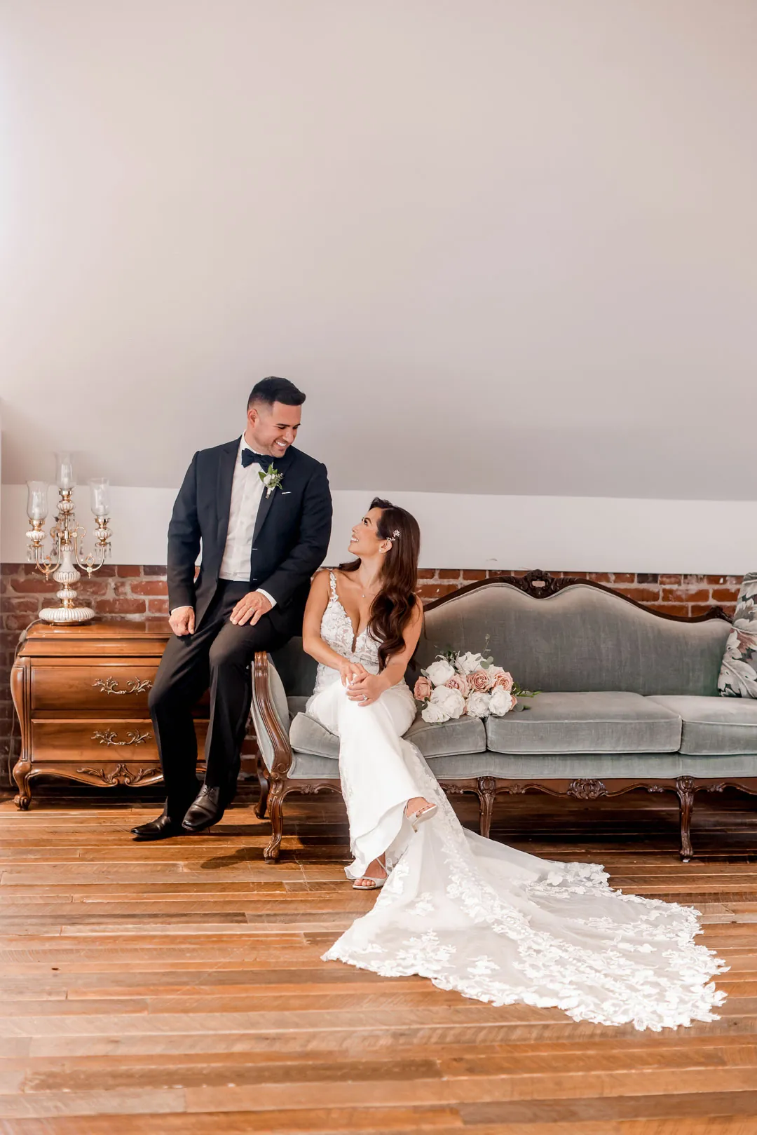 Bride and groom seated together in a lounge