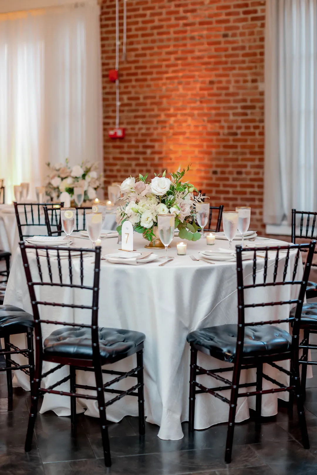 Round reception table with white floral centerpieces