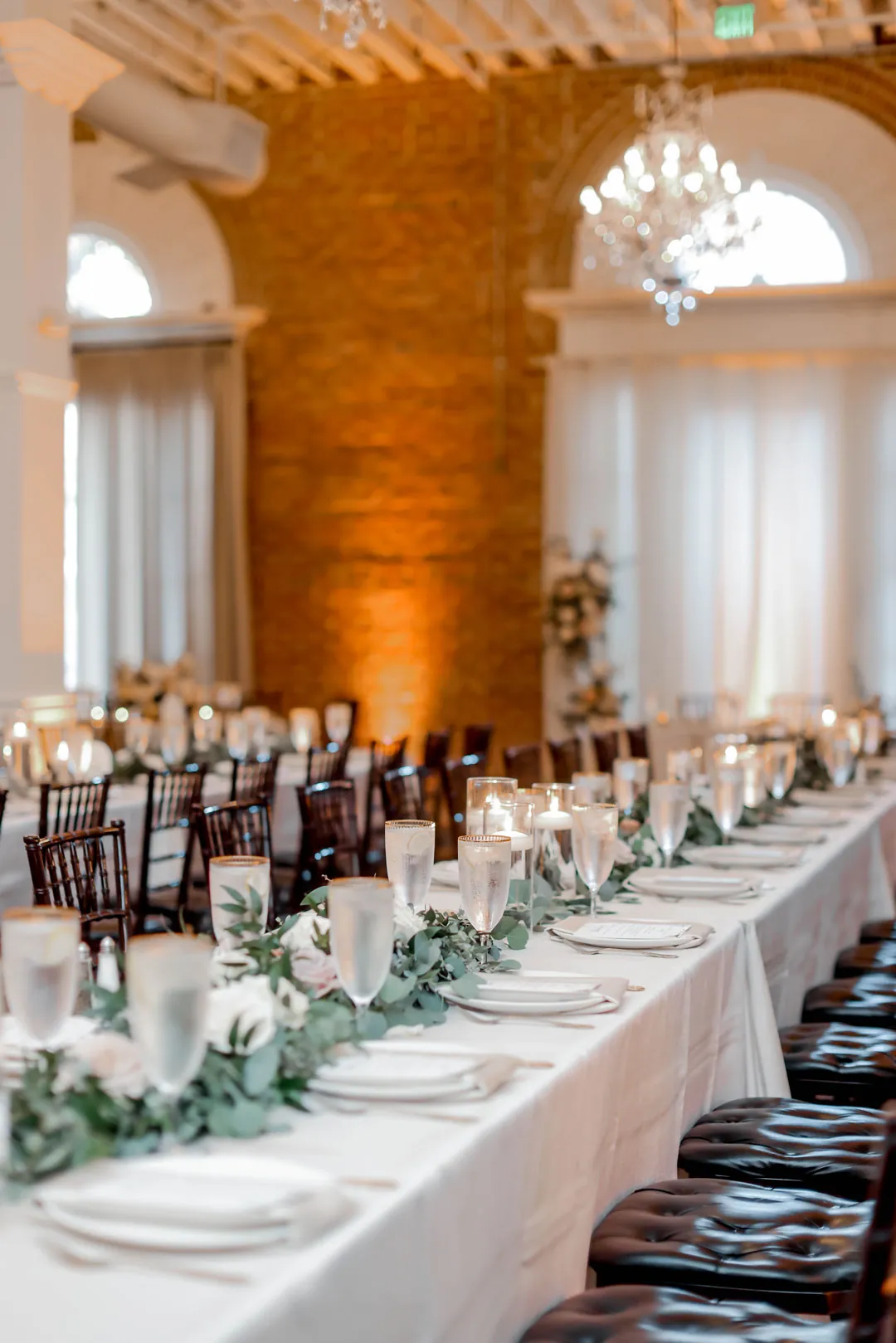 Long reception table with greenery and white flowers