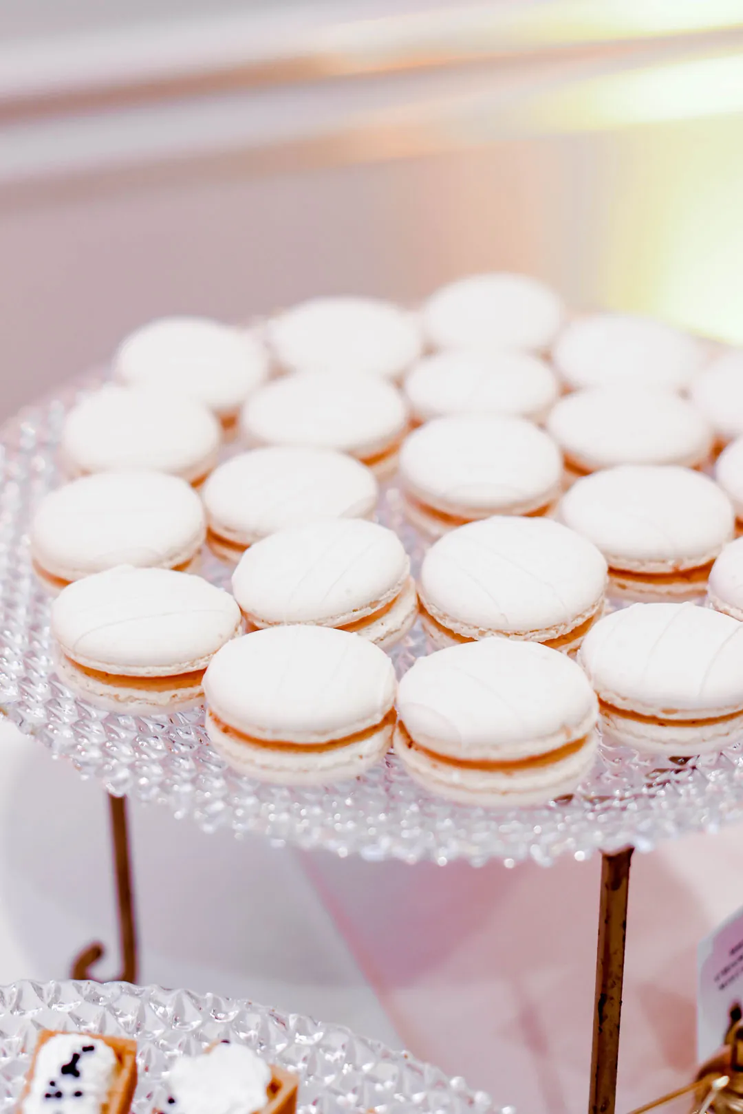 White-frosted mini cupcakes arranged on a tray