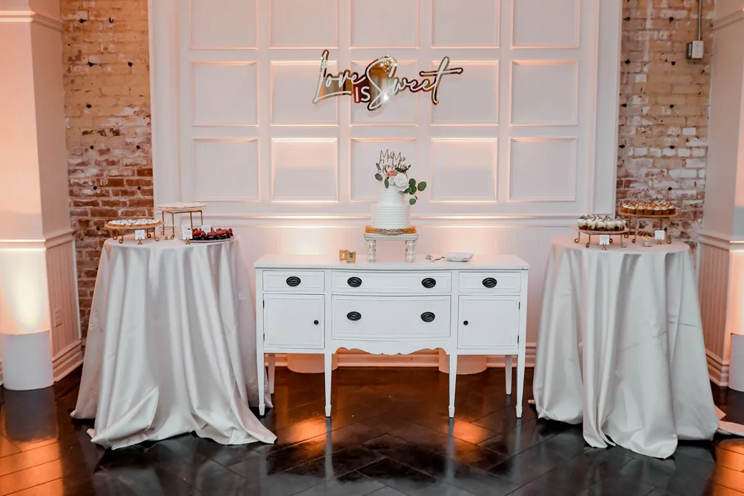 Wedding cake and desserts beside a white cabinet