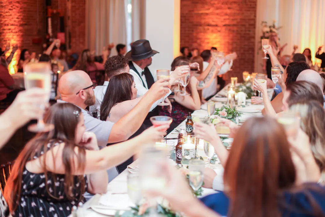 Guests raising glasses in a toast