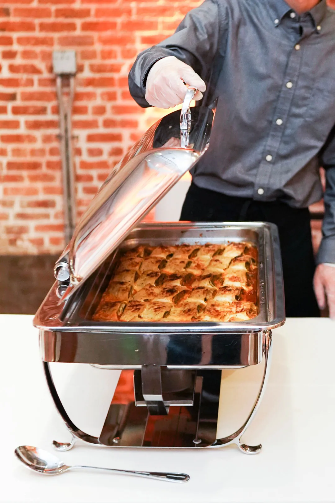 Chef serving food from a buffet tray