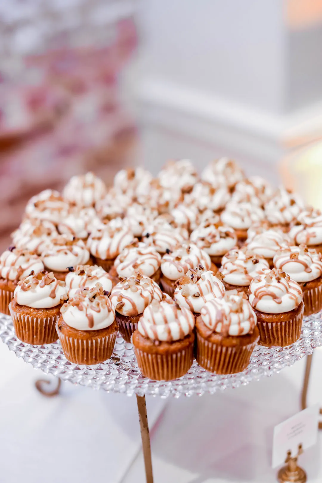 Chocolate-drizzled cupcakes on a round stand