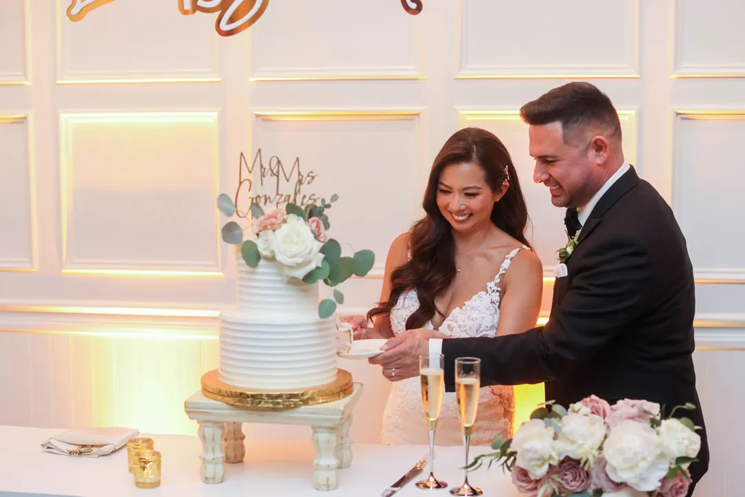 Newlyweds cutting their wedding cake