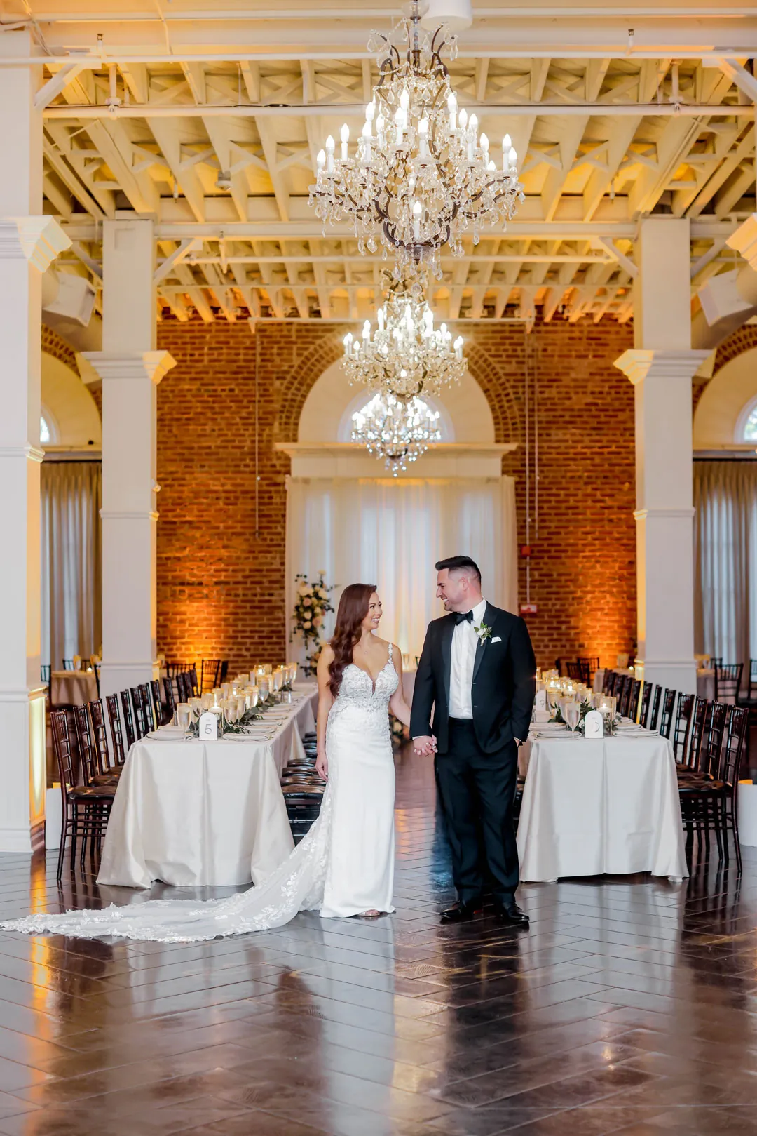Bride and groom walking between reception tables