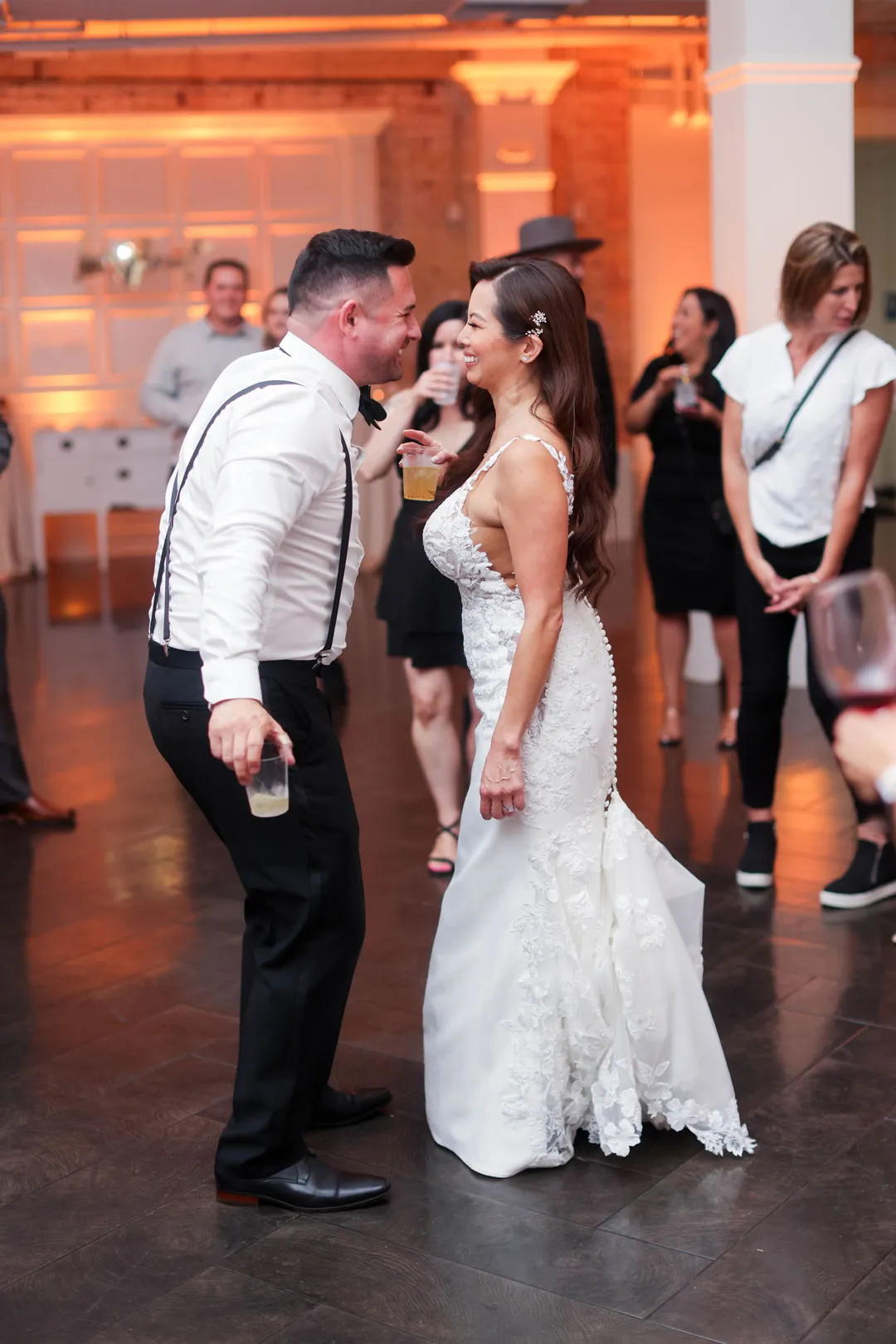 Bride and groom dancing with guests