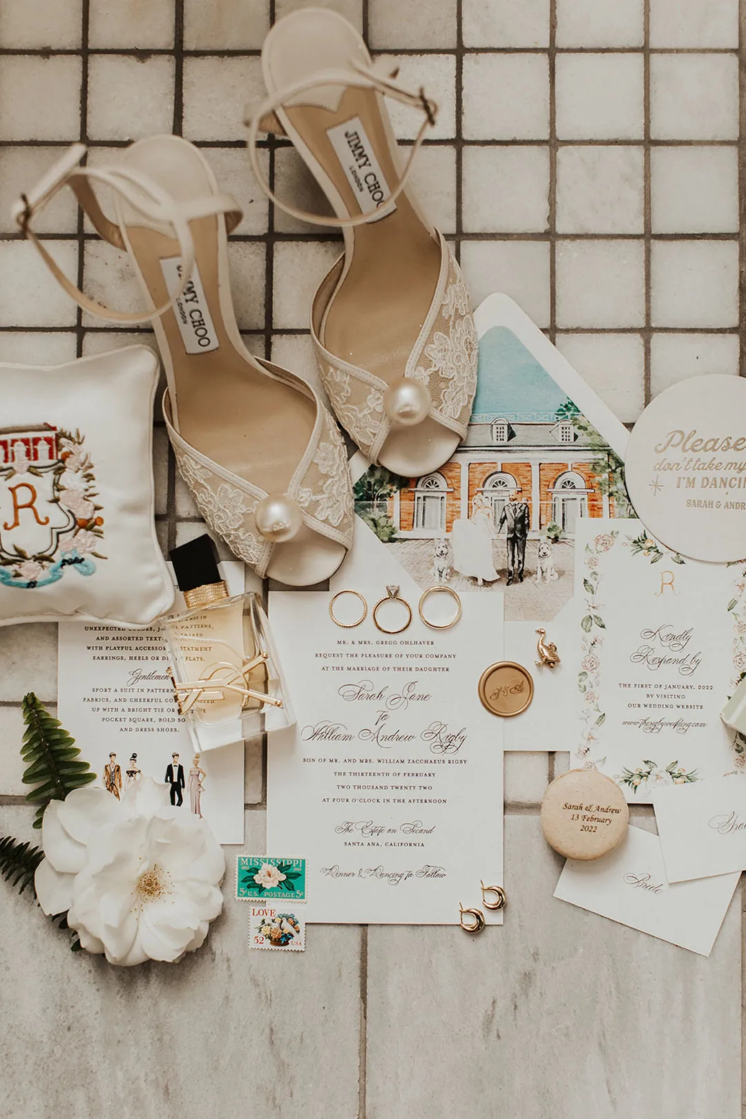 Wedding shoes, jewelry, and invitations arranged together