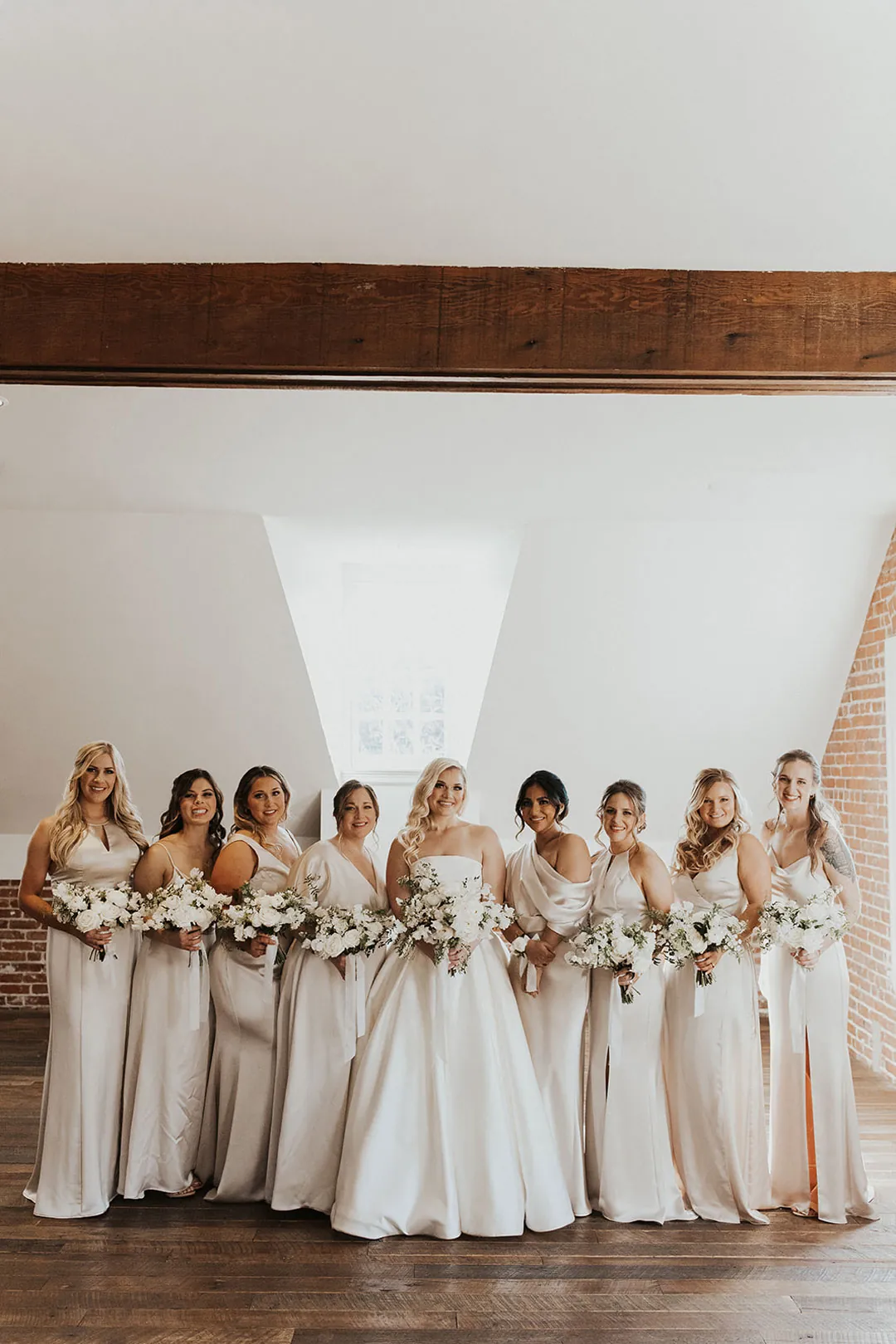 Bride and bridesmaids lined up beneath a sloped ceiling