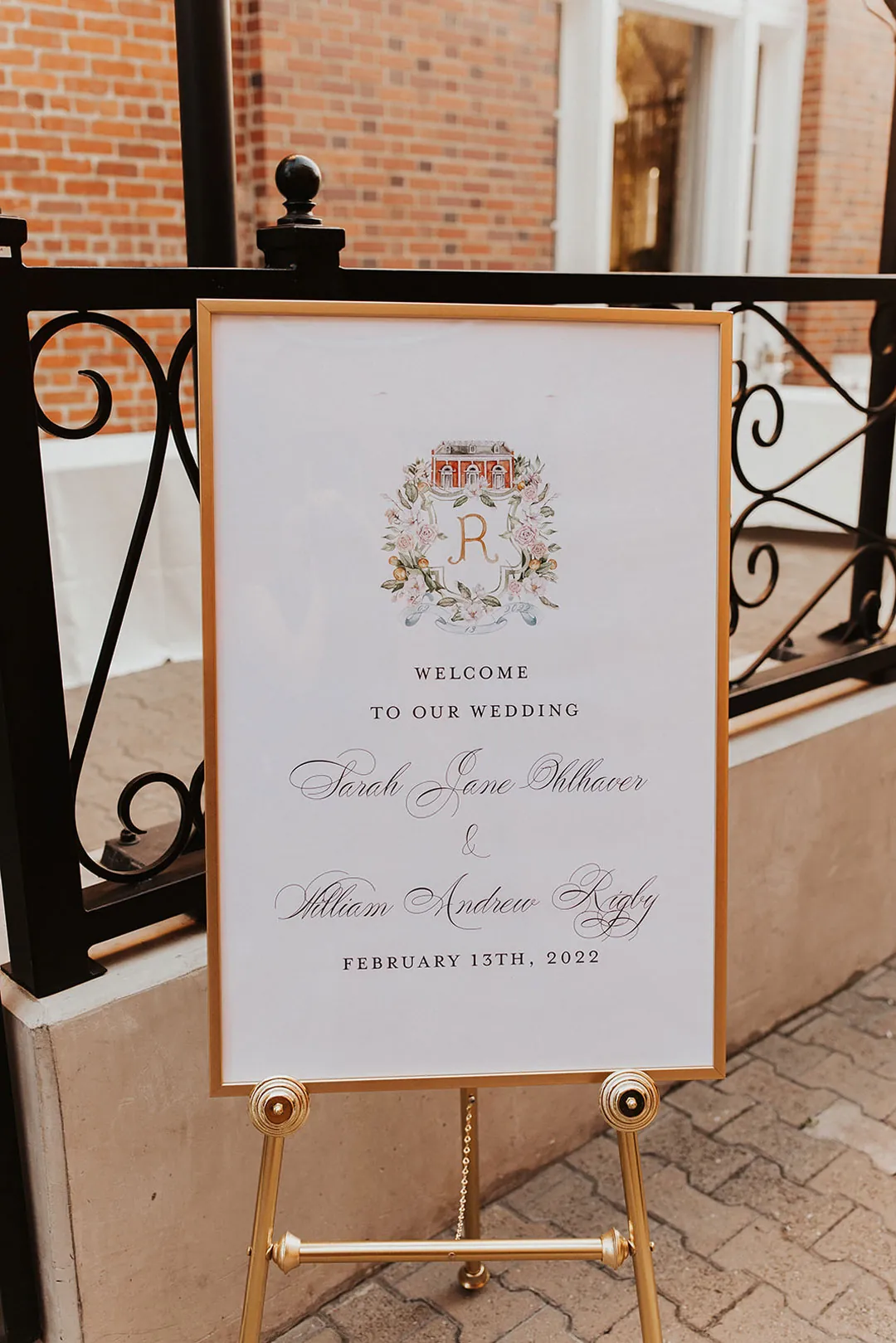 Wedding welcome sign displayed on a gold easel