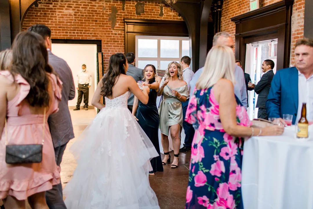 Guests holding drinks and mingling in the reception room