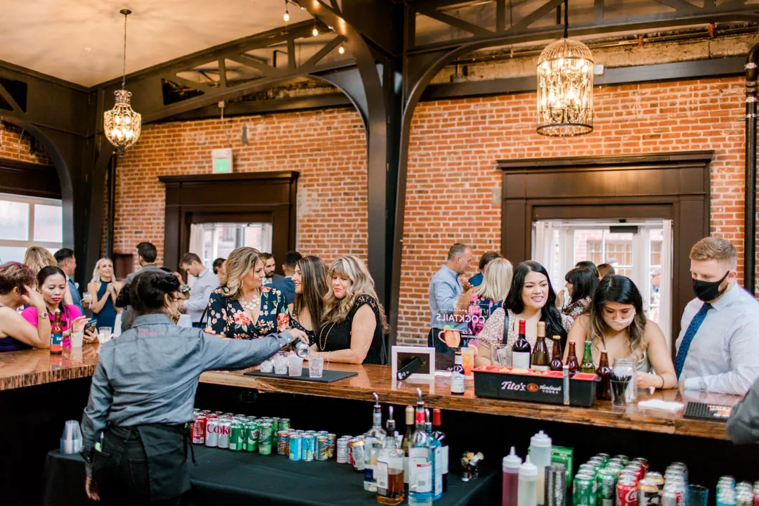 Guests ordering drinks at a wooden bar