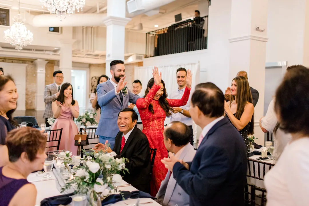 Guests raising glasses around a reception table