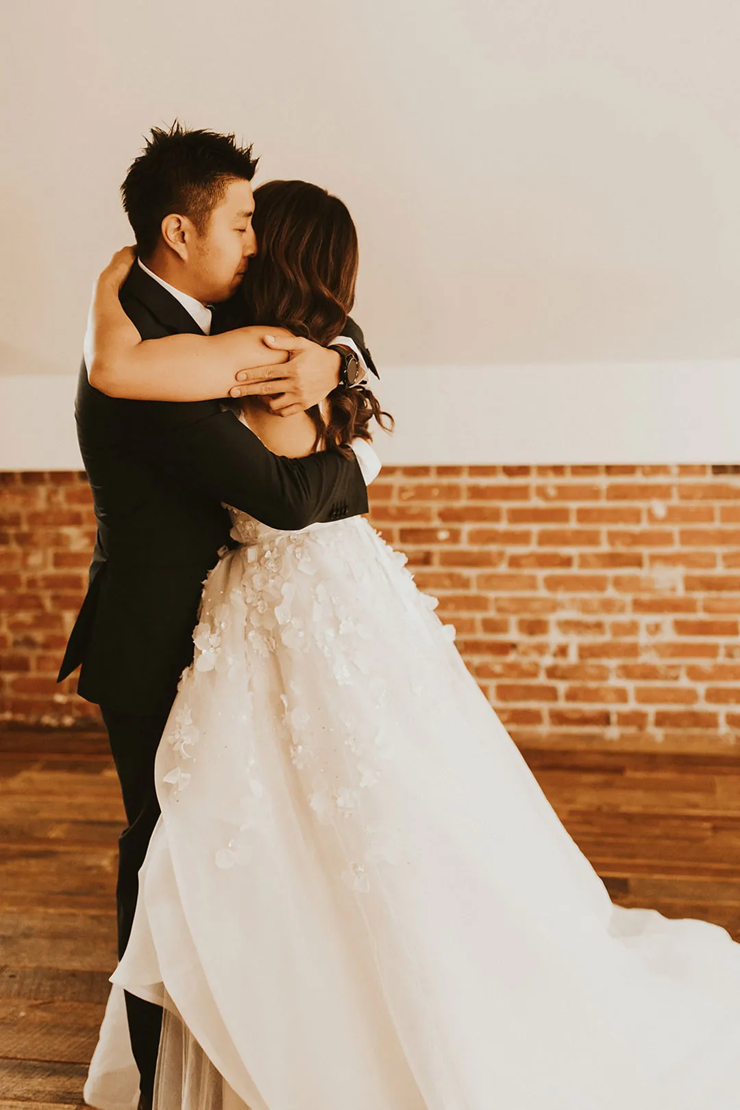 Bride and groom embracing in a sunlit room