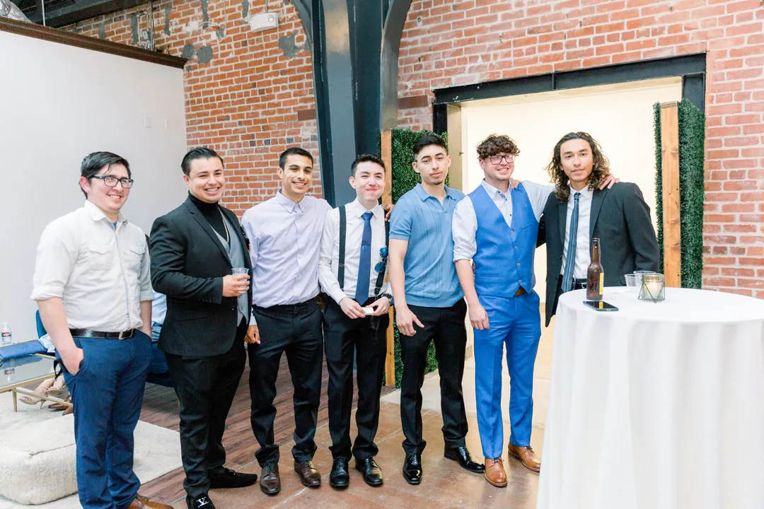 Guests posing beside a cocktail table
