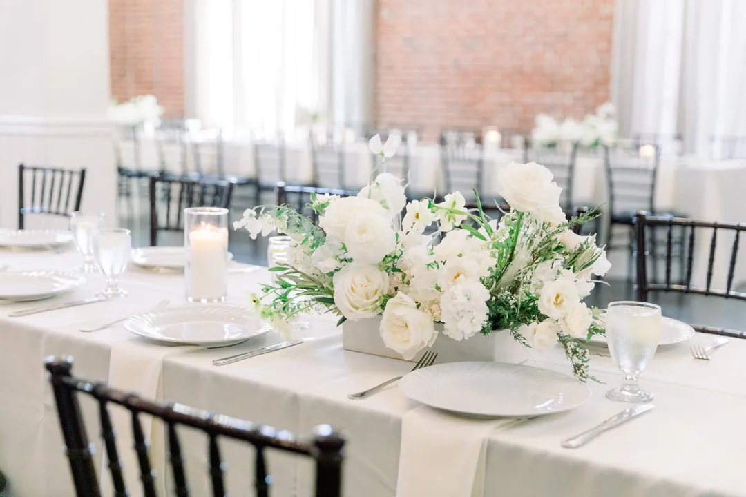 Round reception table with white floral centerpieces