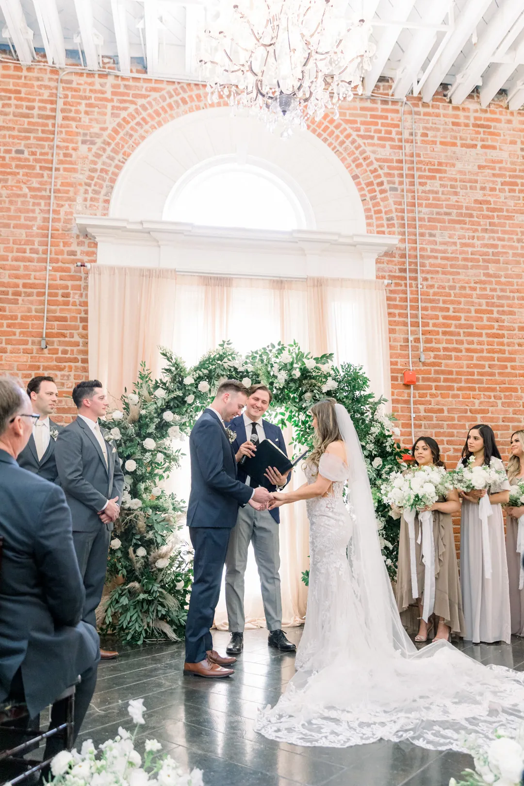 Couple exchanging vows before their guests