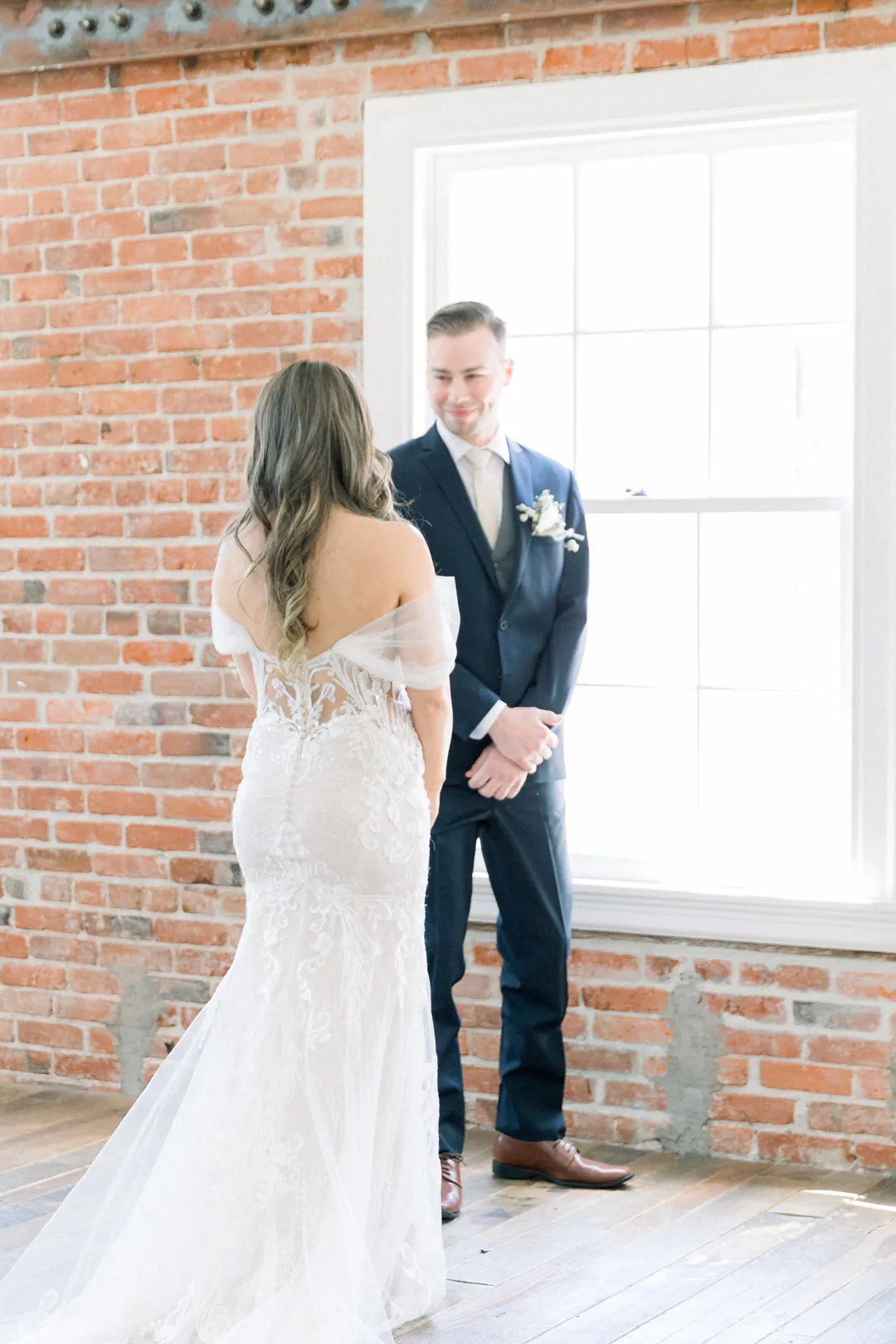 Bride and groom smiling during their first look