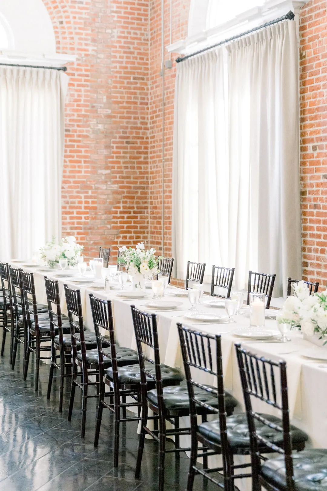 Long reception table with candles and white flowers