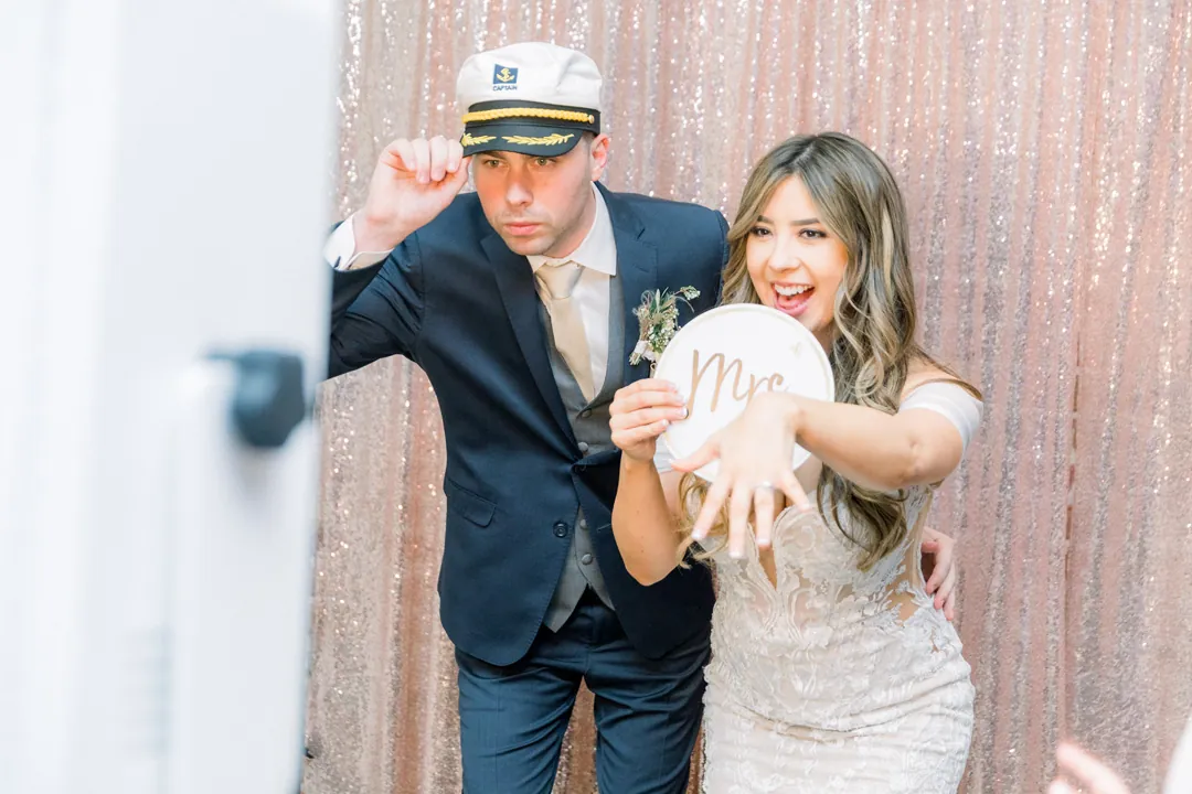 Newlyweds posing with photo-booth props