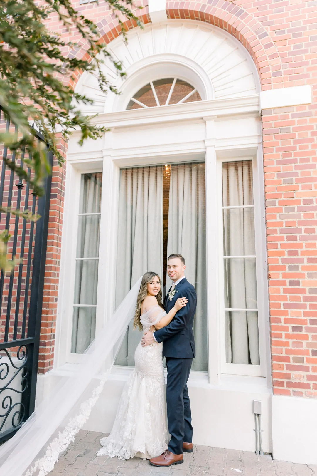 Bride and groom outside the arched venue entrance