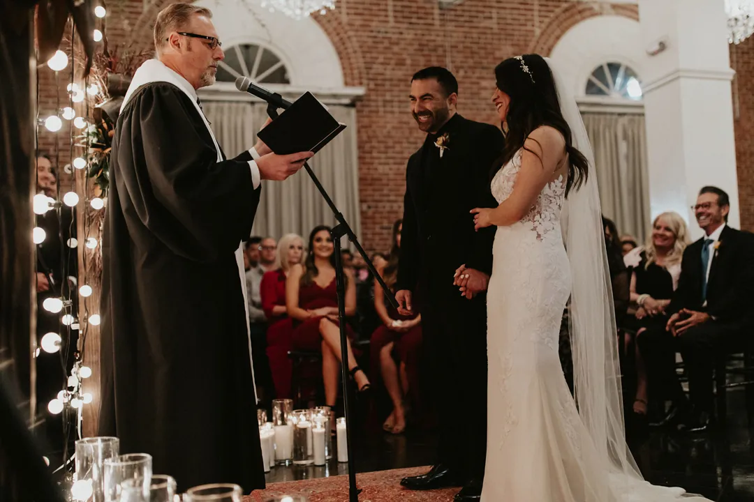Bride and groom facing their officiant