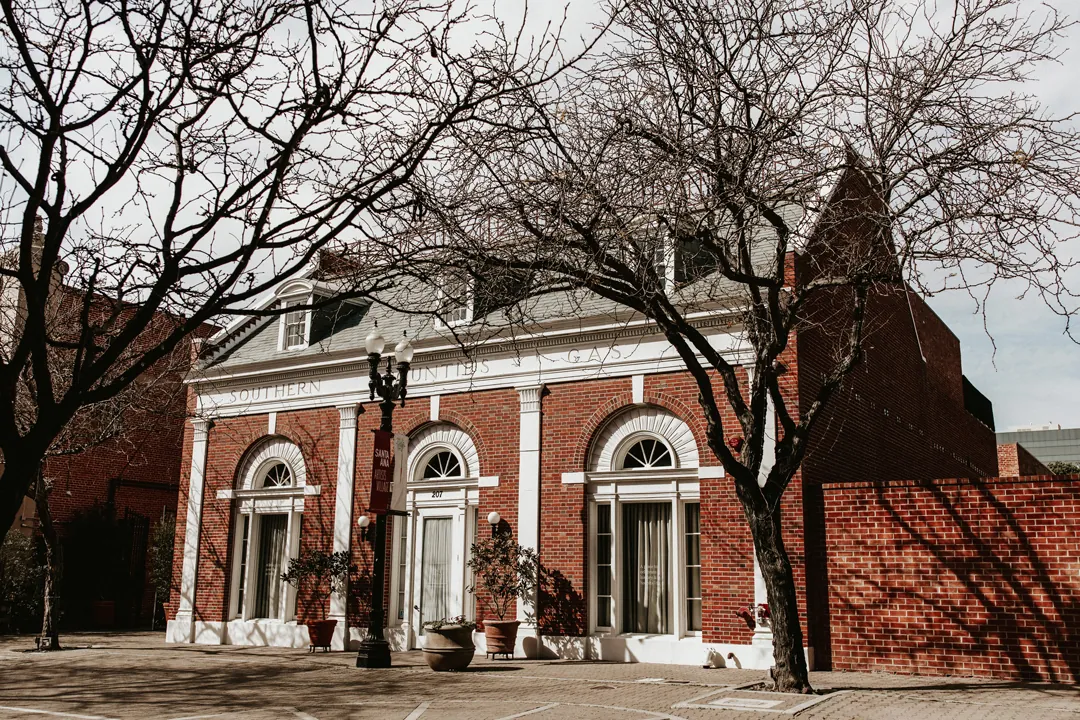 Brick venue exterior beneath bare tree branches