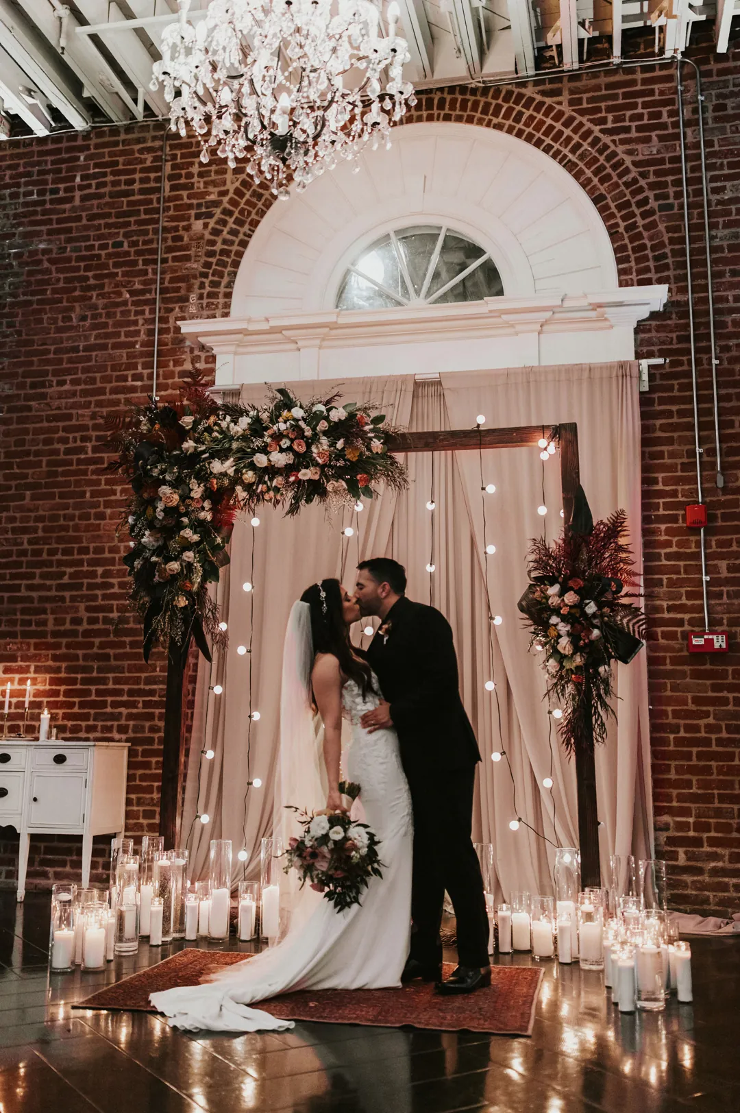 Bride and groom kissing during their ceremony