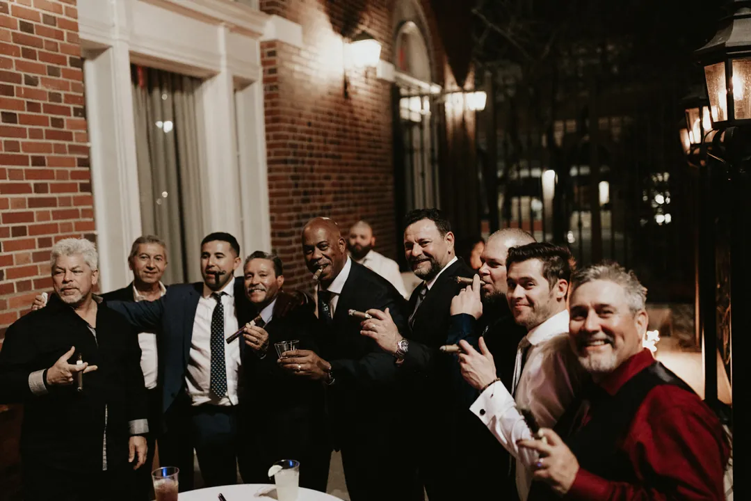 Groom celebrating with guests at a reception table