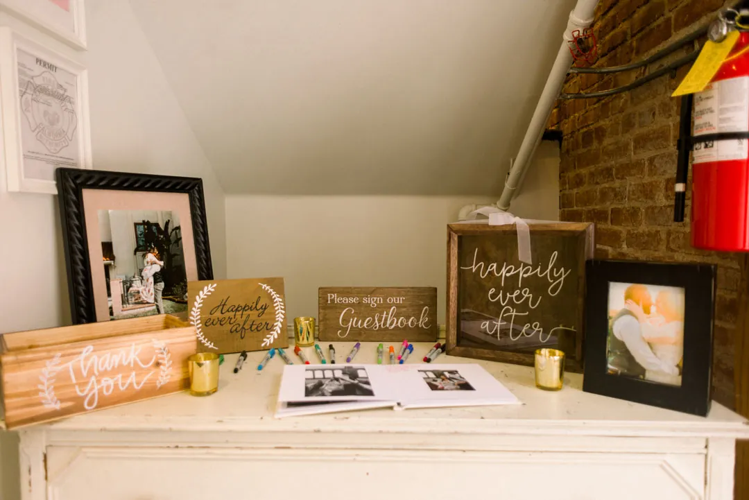 Wedding photos and decorative signs displayed on a table