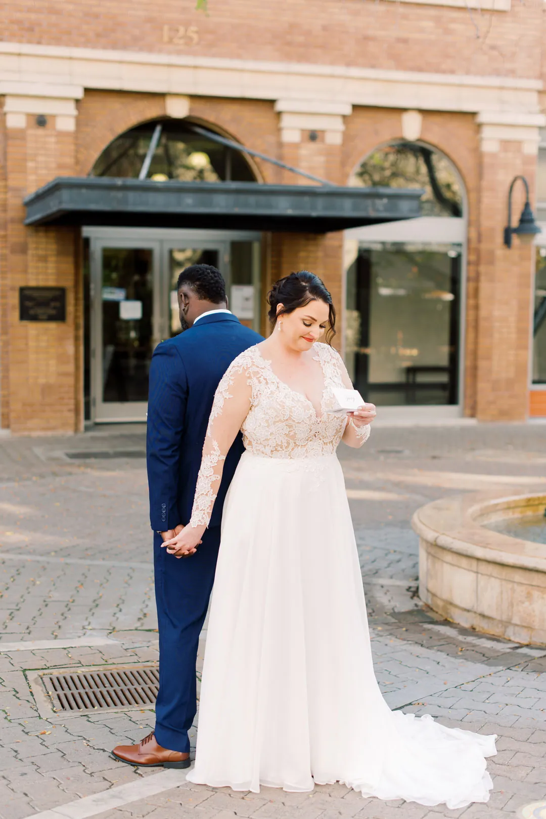 Couple standing outside a brick building