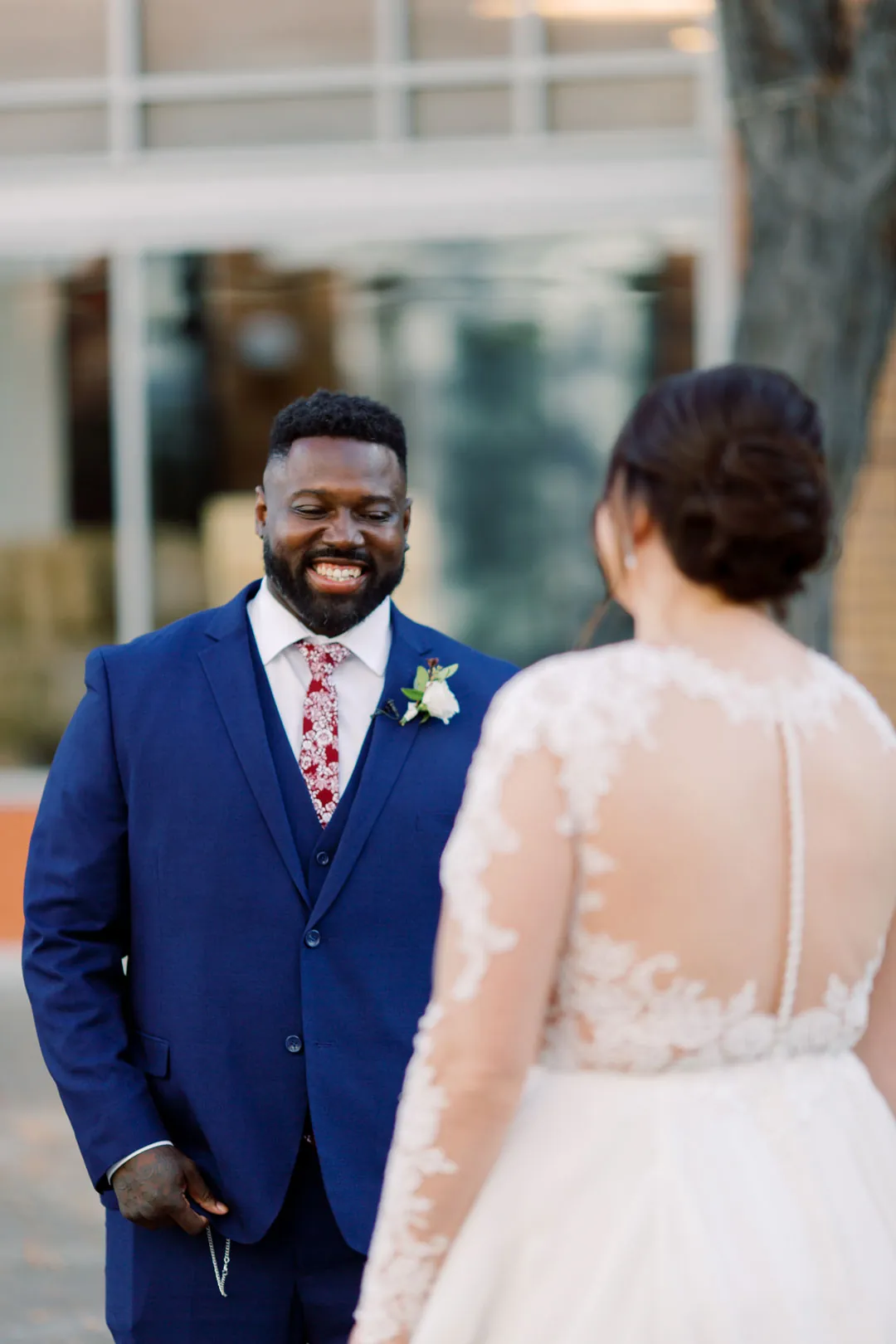 Groom smiling as the bride approaches