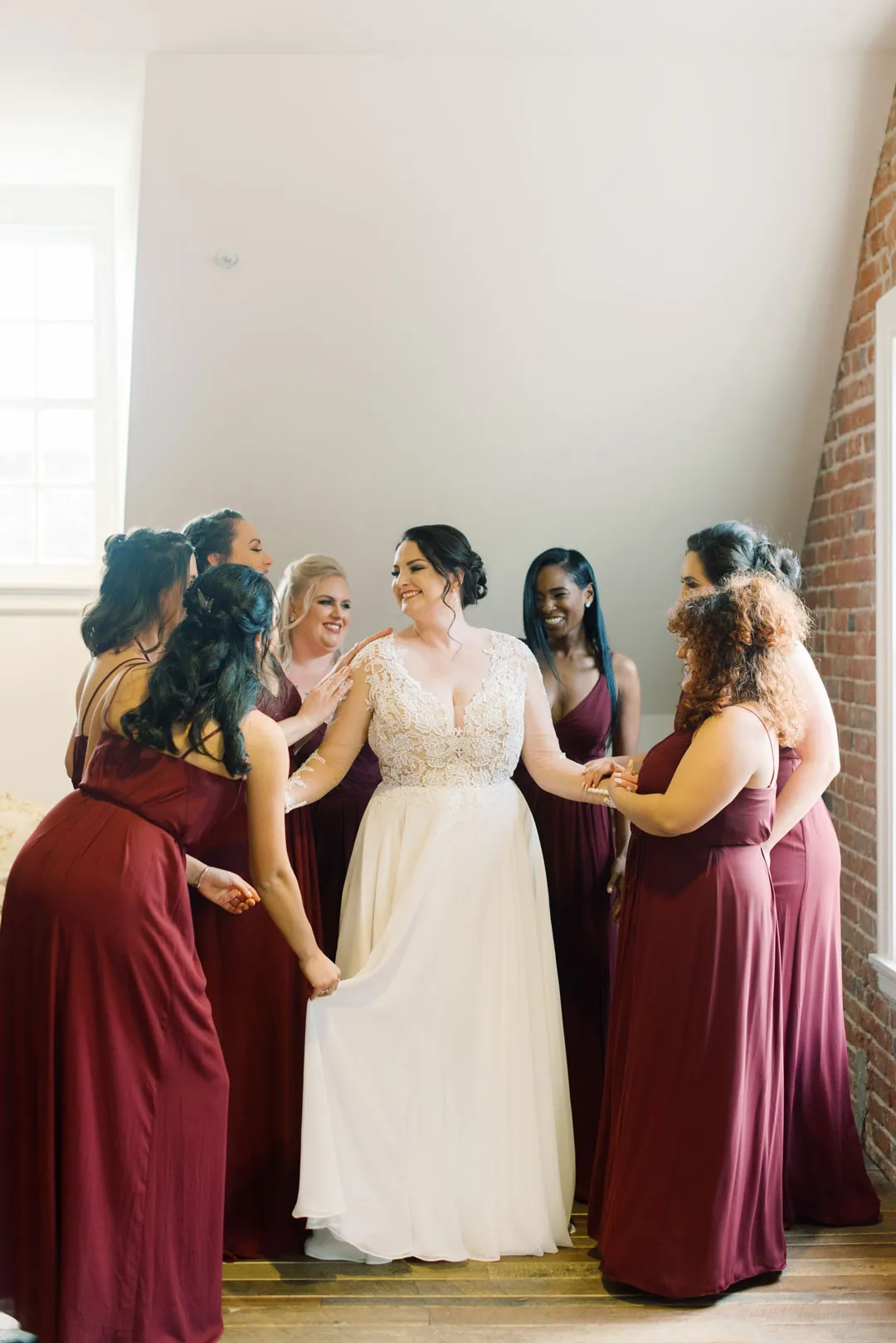 Bride and bridesmaids gathered in a bright room