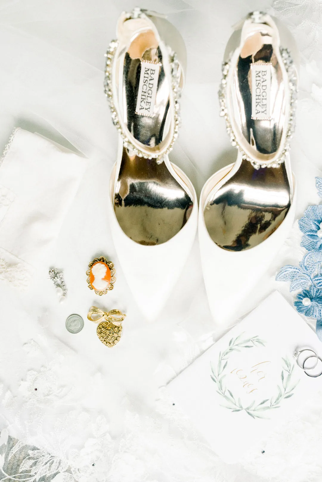 Wedding shoes, jewelry, and small accessories arranged together