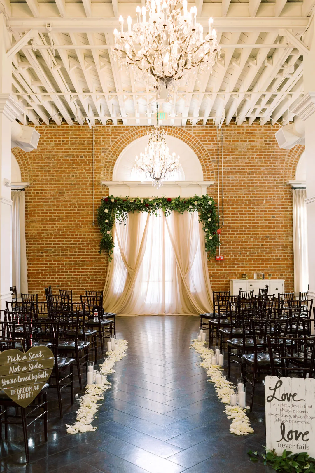 Center aisle leading to a draped ceremony backdrop
