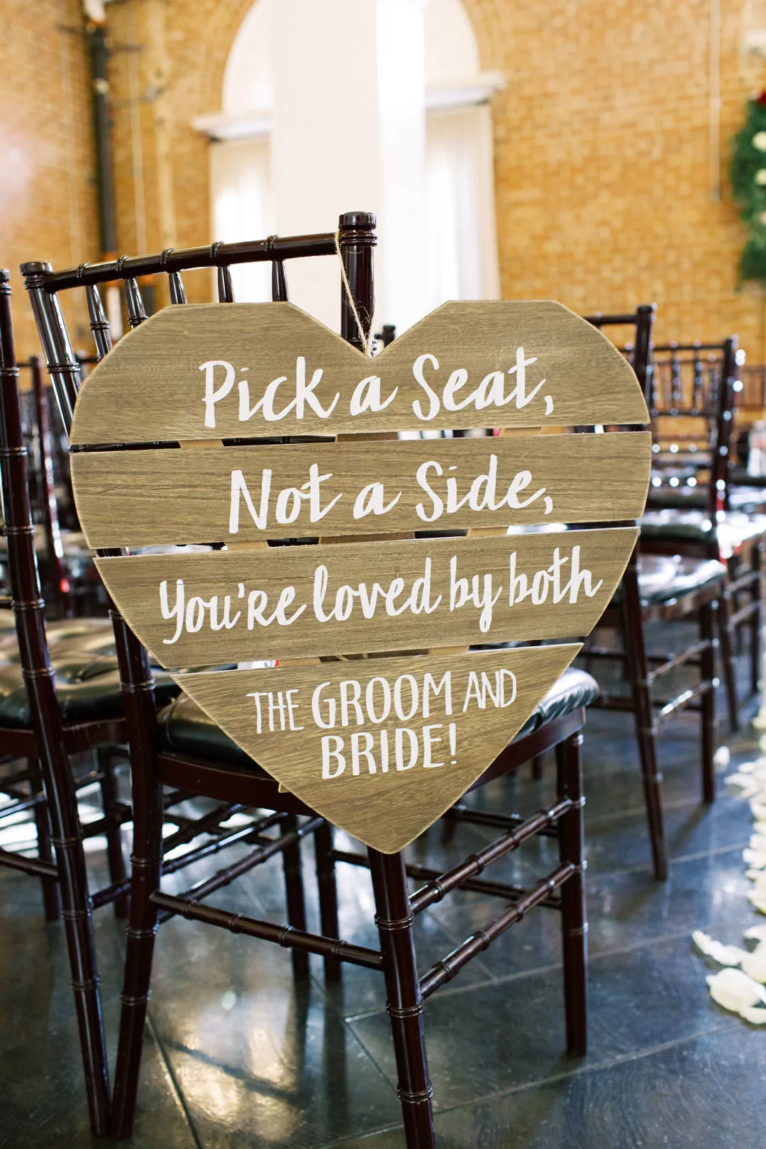 Sign inviting wedding guests to choose any seat