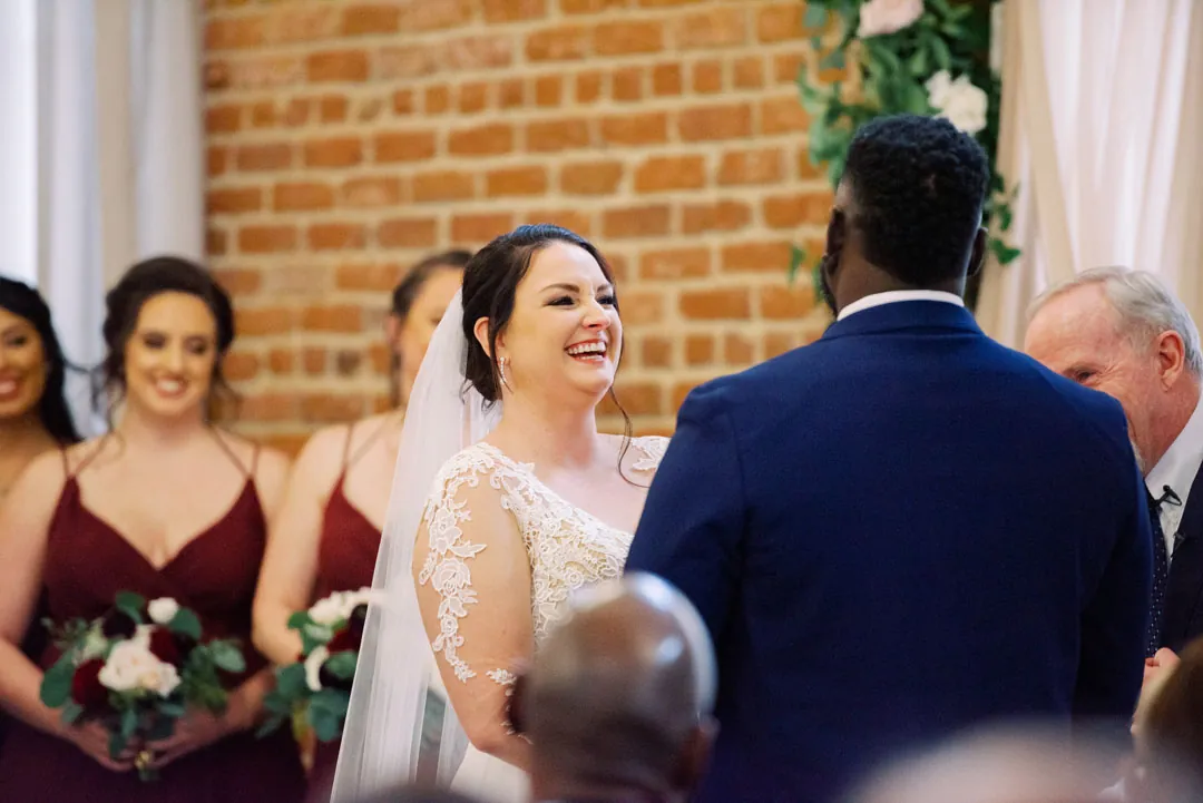 Bride smiling at the groom during the ceremony