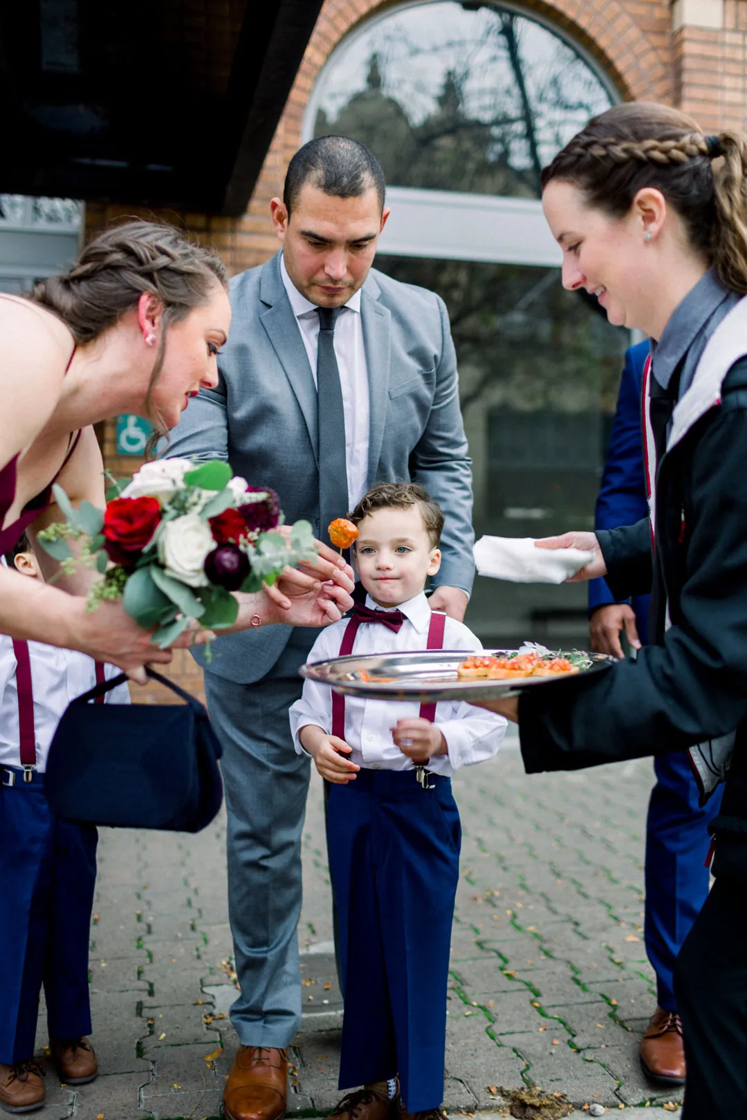 Guests gathered around a tray of drinks outdoors