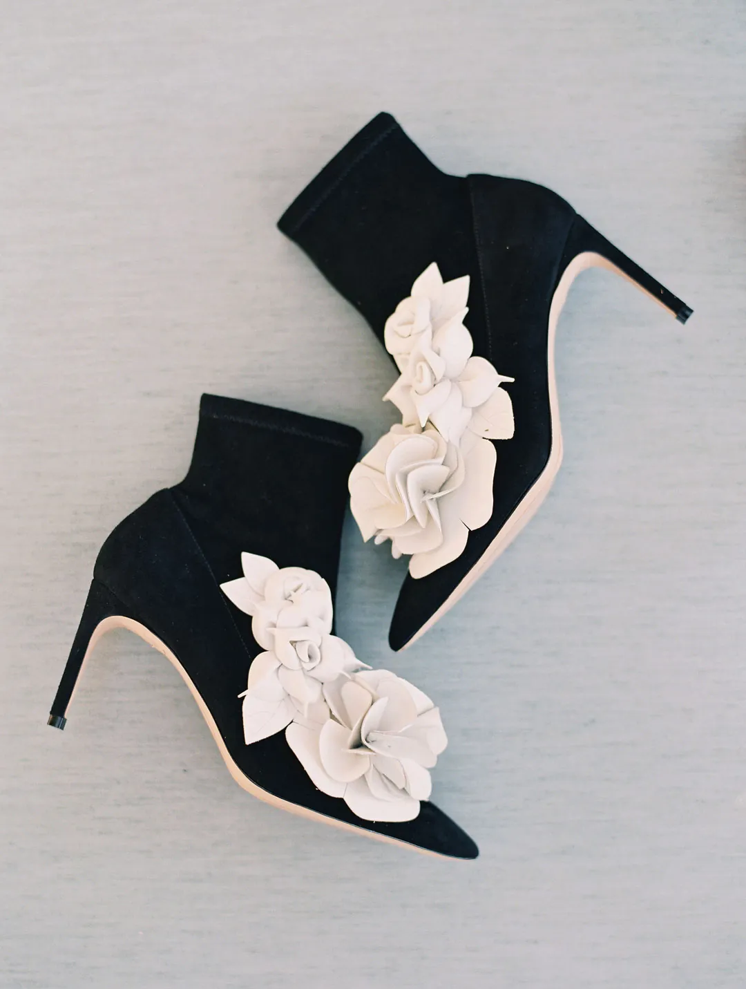 Black wedding shoes decorated with pale flowers