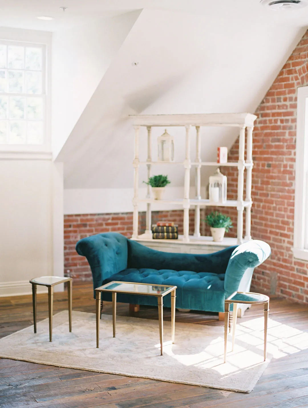 Blue lounge chairs and a coffee table beneath a sloped ceiling