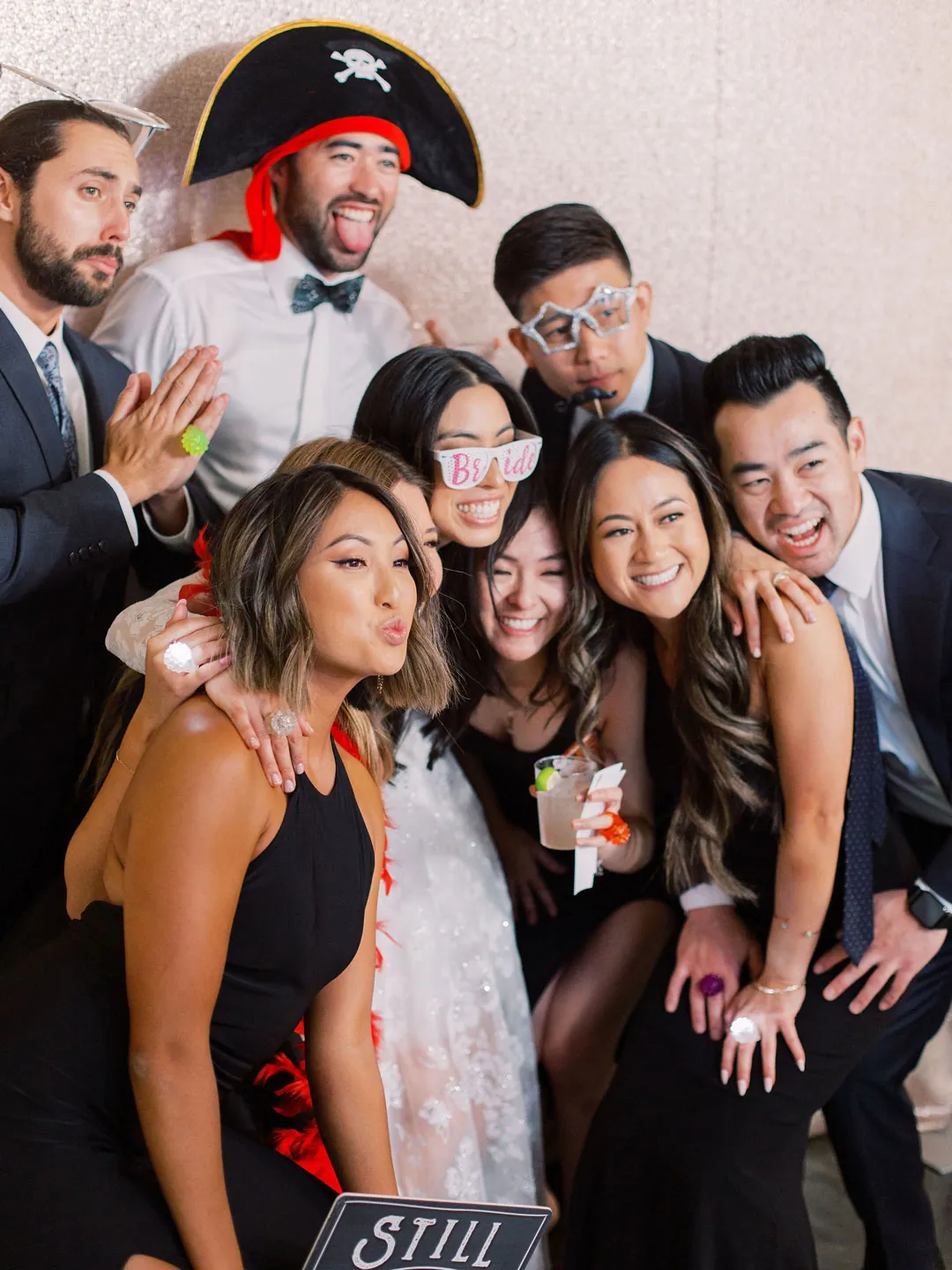 Guests posing together with colorful photo booth props