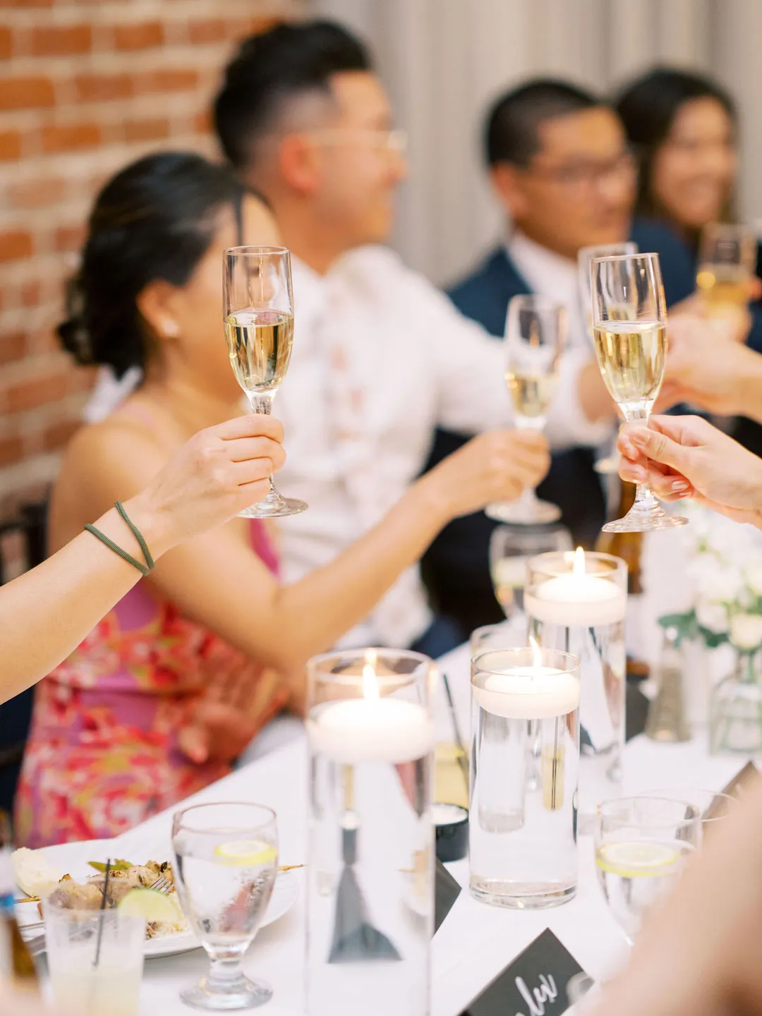 Guests raising glasses around a reception table