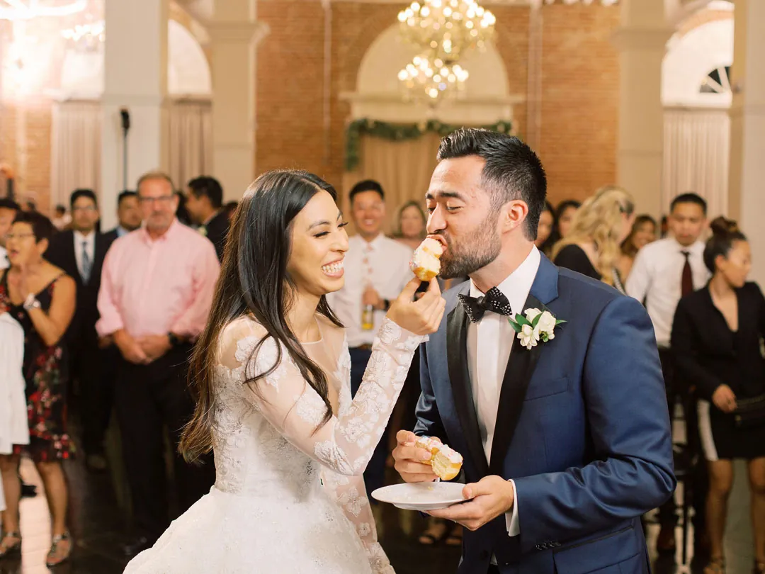 Couple standing together as guests gather around them