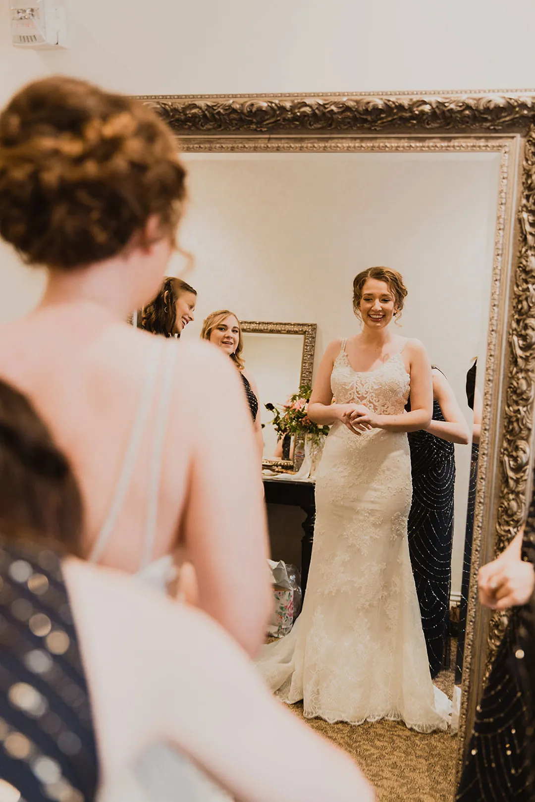 Bride reflected in an ornate mirror