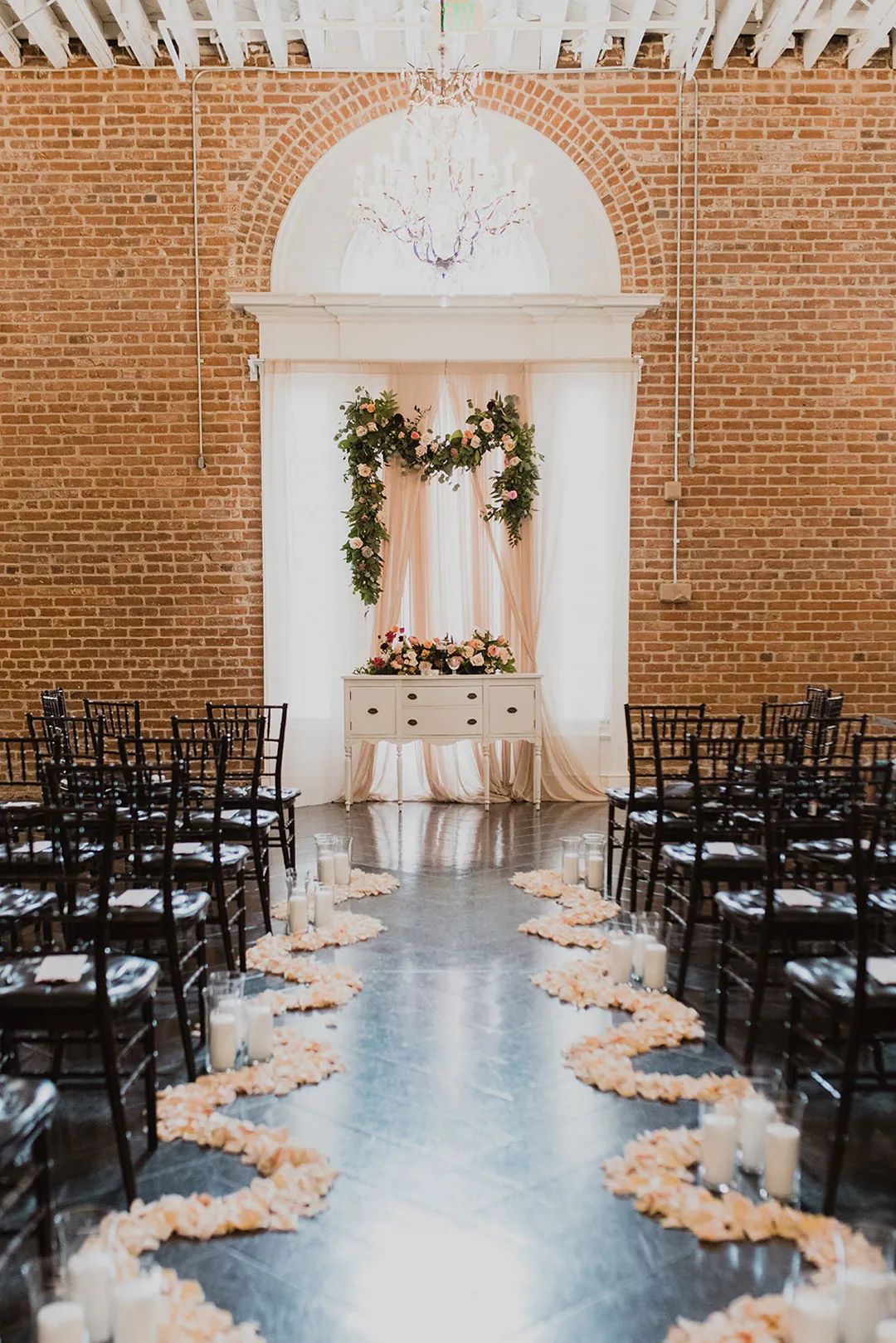 White petals lining an empty ceremony aisle