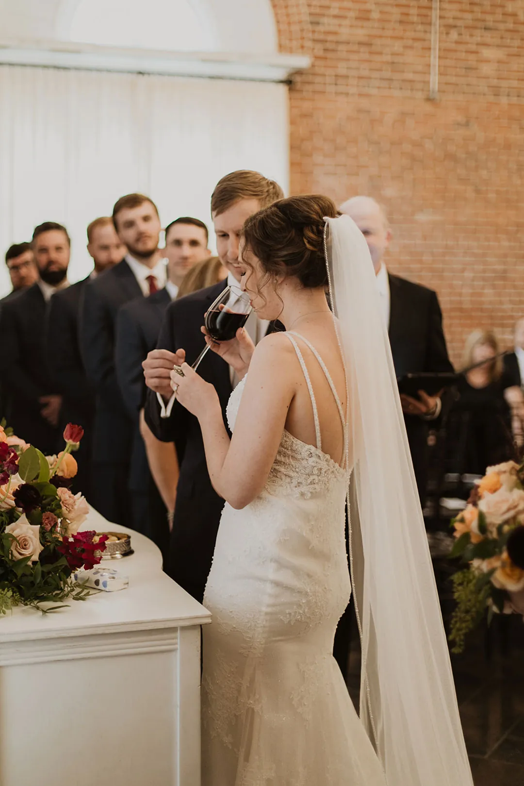 Bride wiping her eyes during the wedding ceremony
