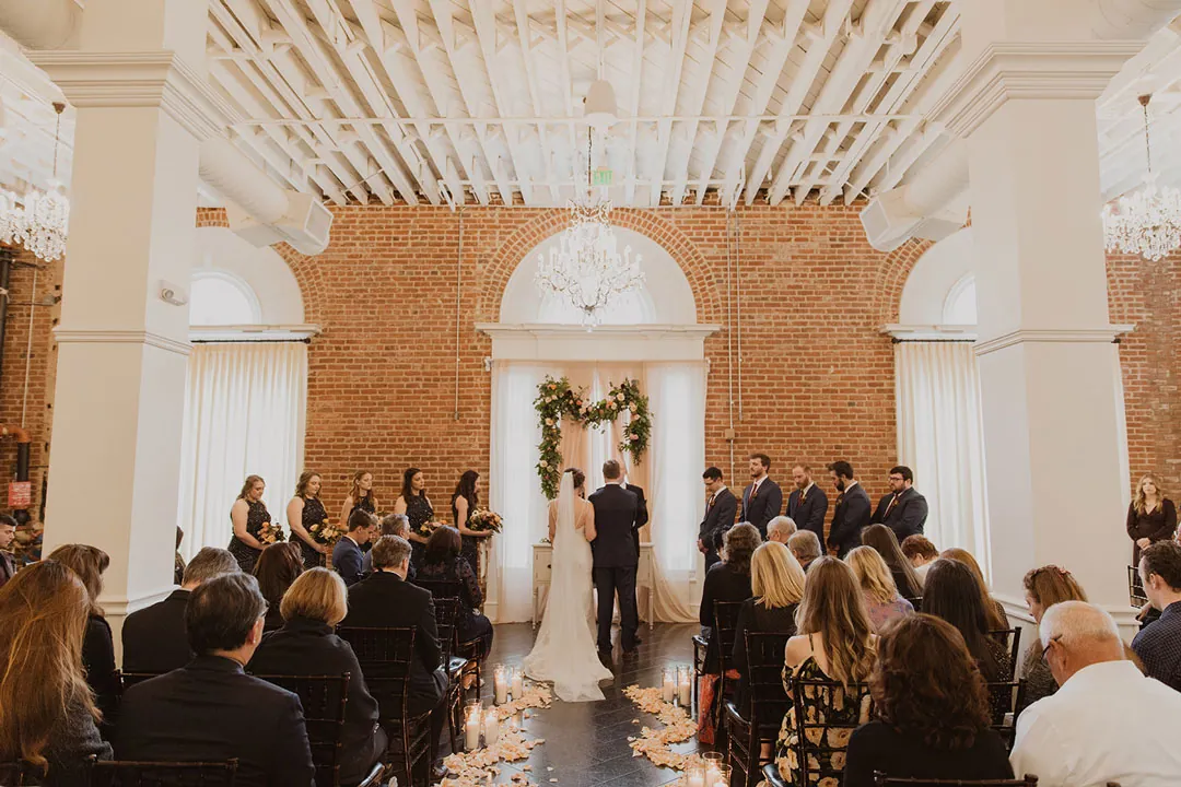 Seated guests facing the couple during a wedding ceremony