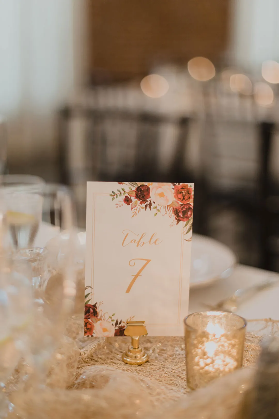 Table number seven beside gold candleholders