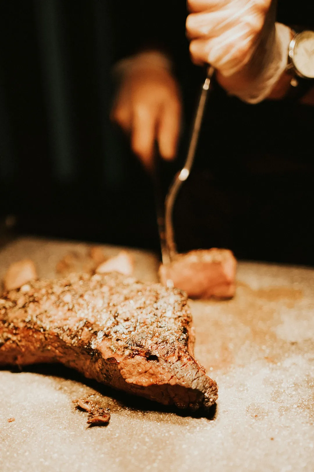 Chef carving food on a wooden board